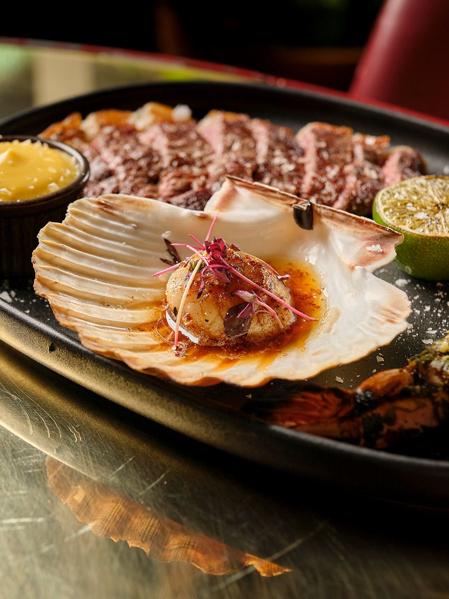 Lobster, steak and seafood over fire at temper City