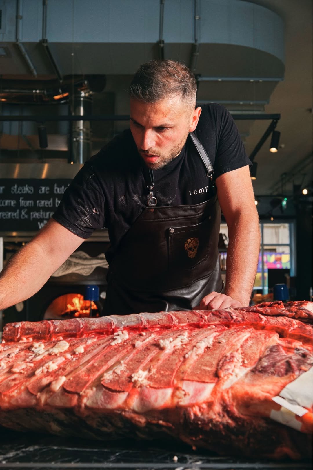 Butcher preparing rare-breed beef at temper